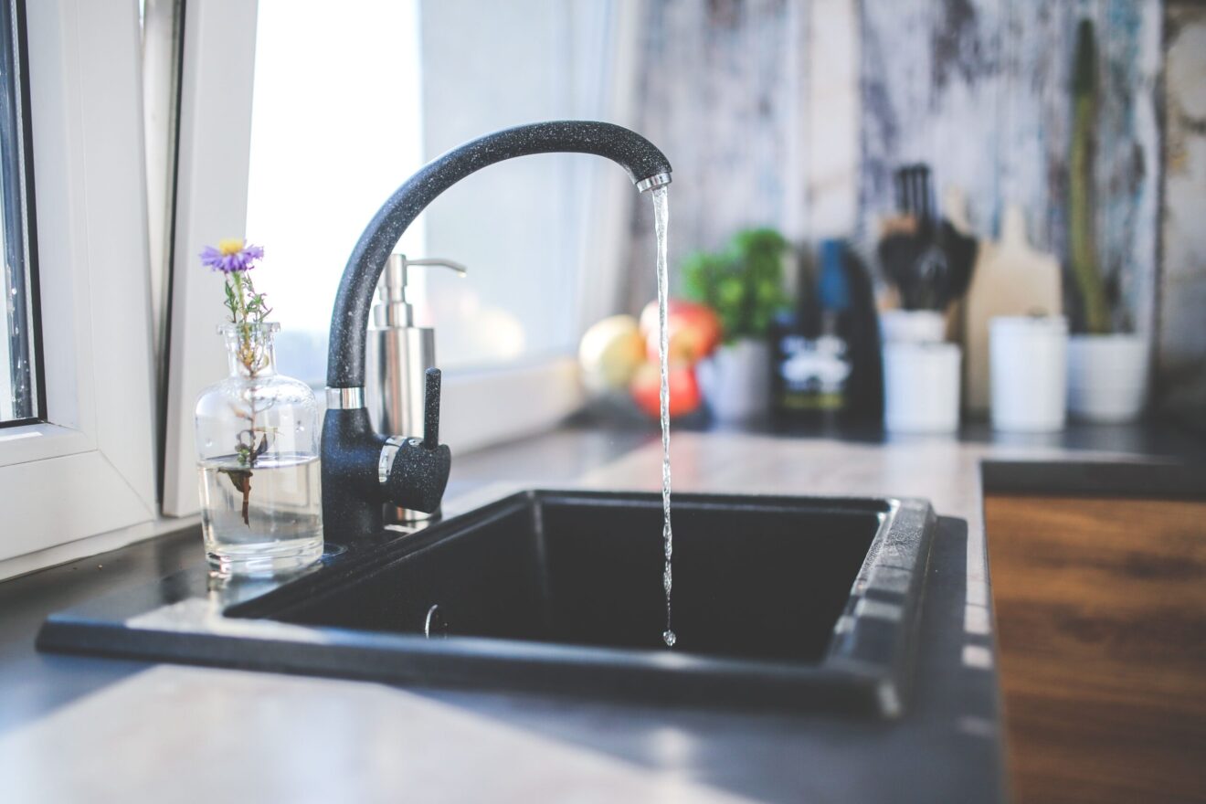 Water running from a tap into a sink