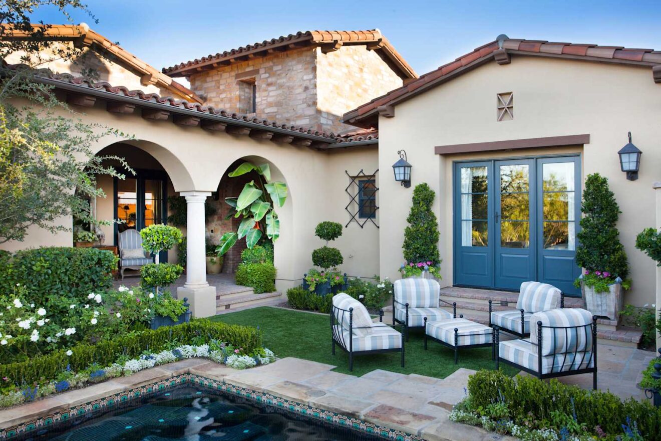 A Spanish colonial-style house with an arcade, patio and pool